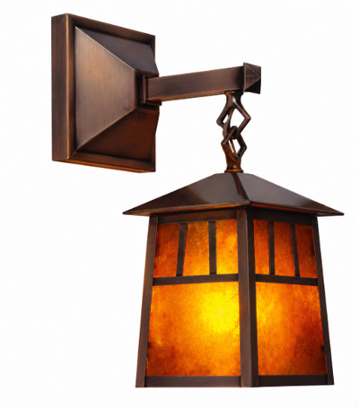A modern outdoor wall sconce with a dark bronze metal frame and warm amber-orange textured glass panels, shown against a plain white background.