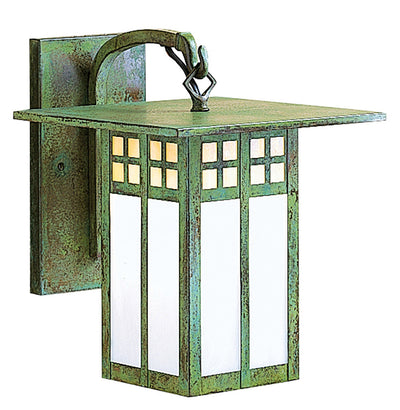 Green metal wall light fixture with glass panels on a white background