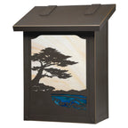 A rectangular outdoor light box with a dark bronze finish, featuring a decorative front panel with a black metal silhouette of a pine tree and blue water, set against a cream and gold sky.