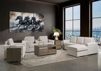 A staged modern living room featuring a light beige sectional sofa with a chaise, matching armchairs, a wooden coffee table, and a large multi-panel canvas wall art print depicting four black horses against a smoky background.
