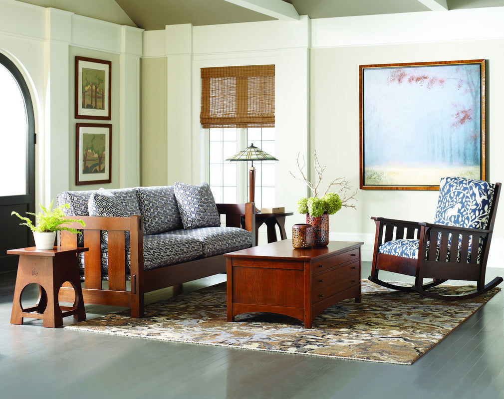 Living room with wooden furniture, a sofa, and decorative elements. Includes the Roycroft Table by Stickley. 