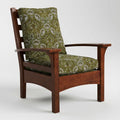 Wooden armchair with green patterned cushions on a white background