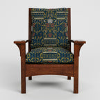 Wooden armchair with patterned fabric cushion on a white background