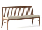 Wooden bench with beige cushion on a white background