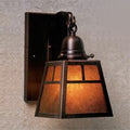 Vintage-style wall sconce with a warm glow on a neutral background