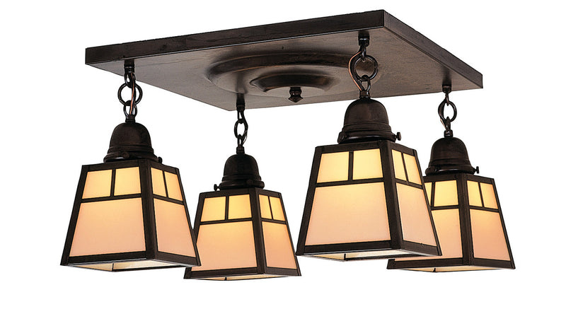 Ceiling light fixture with four glass shades on a white background