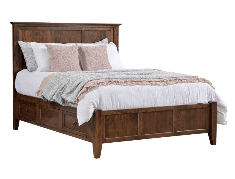 A rustic brown wooden bed frame with a headboard, footboard, and built-in storage drawers on the bottom, styled with white bedding, blush pink pillows, and a textured throw blanket, set against a plain white background.