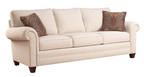 Beige sofa with brown patterned pillows on a white background