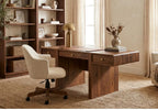 A mid-century modern wooden writing desk with a matching cream upholstered swivel chair, set in a warm, sunlit home office with a wooden bookshelf and window.