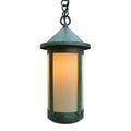 Green outdoor pendant light with a white shade on a white background