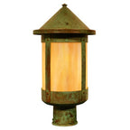 Decorative outdoor light fixture with a warm glow on a white background