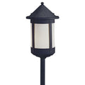 Black outdoor lamp post with white glass on a white background