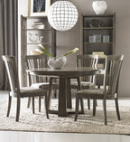 Dining room with wooden table and chairs, bookshelves, and decorative items.