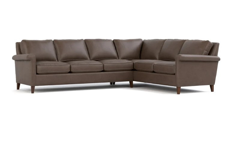 A brown leather sectional sofa with a right-facing L-shape, featuring plush seat cushions, back cushions, and tapered dark wood legs, shown against a plain white background.