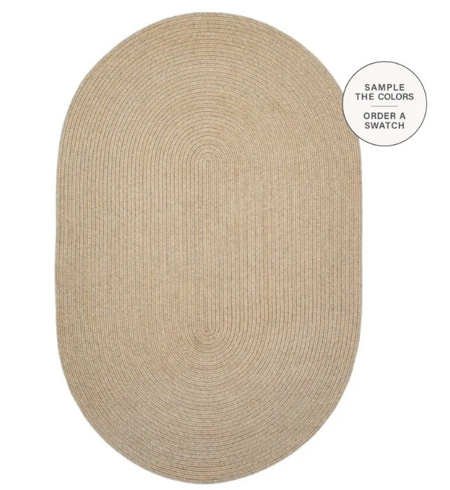 An oval natural jute rug in a light tan color, shown from a top-down view on a white background with a circular callout in the top right that reads 'SAMPLE THE COLORS ORDER A SWATCH'.