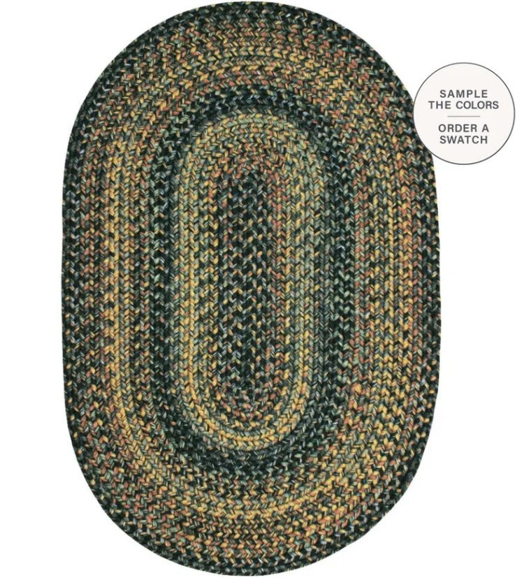 An oval braided area rug with concentric bands of dark green, black, tan, and brown, shown on a white background with a circular callout in the top right.