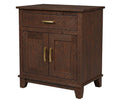 A dark brown wooden cabinet with a single drawer on top and two paneled doors below, featuring brass-finished handles and legs, shown against a plain white background.