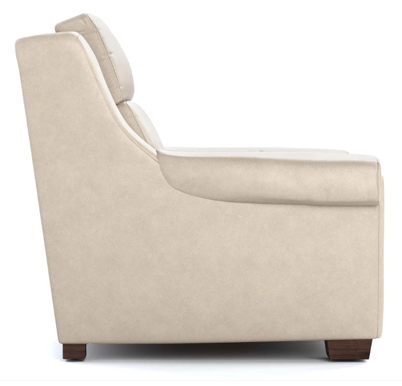 Side view of a modern armchair in a light beige textured fabric, featuring a high back, wide armrests, and dark brown wooden feet, shown against a plain white background.