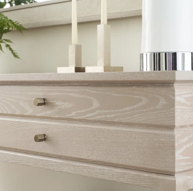 Close-up of a wooden dresser with drawers and decorative elements.