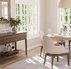 Dining room with wooden table, chairs, and a sideboard.