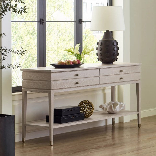 Console table with decorative items in a room with large windows