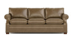 A three-seat leather sofa in a warm taupe-brown color, featuring rolled arms, three back cushions, three seat cushions, and nailhead trim along the front apron, shown against a plain white background.