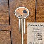 Wooden inlay with labeled wood species on a wooden surface