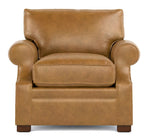 A classic brown leather armchair with rolled arms, a thick seat cushion, and dark wooden feet, shown against a plain white background.