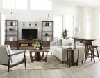 Modern living room with white sofa, armchair, and wooden coffee table.