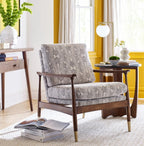 Patterned armchair in a living room with yellow walls and decor.