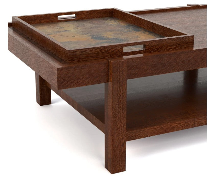A close-up of a dark brown wooden coffee table with a built-in tray on top featuring a textured, distressed metallic pattern, set against a plain white background.