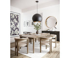 Dining room with wooden table and chairs, black pendant light, and decorative elements.