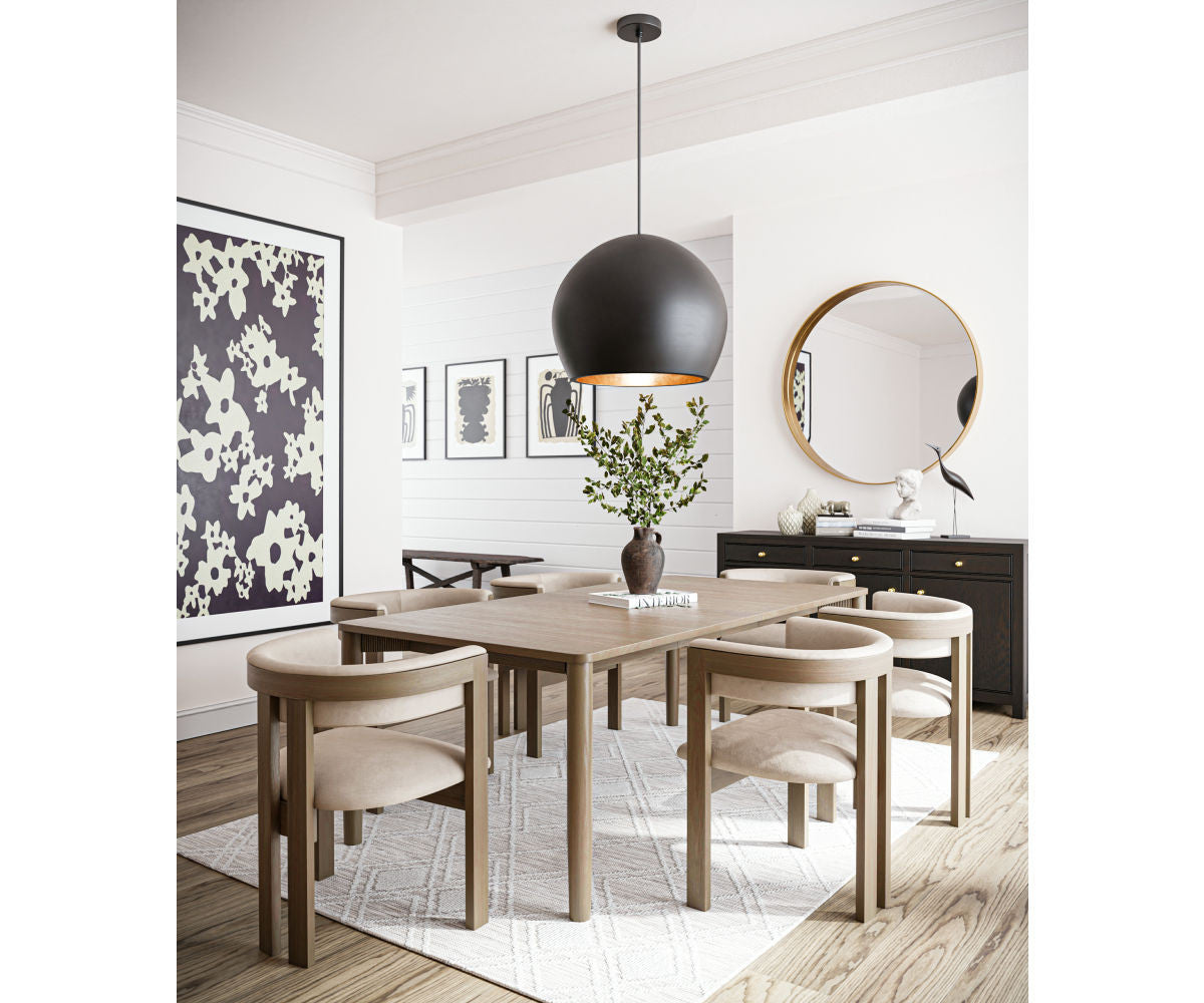 Dining room with wooden table and chairs, black pendant light, and decorative elements.