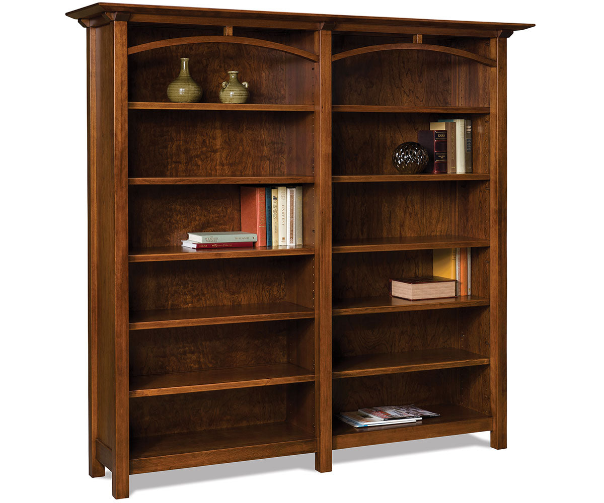 Wooden bookshelf with books and decorative items on a white background