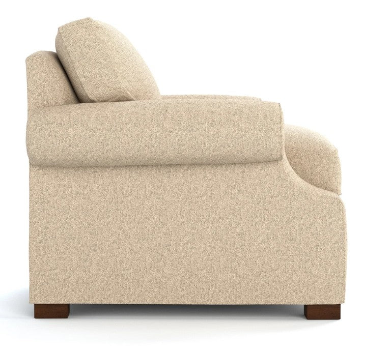 Side view of a modern armchair upholstered in a textured beige fabric, featuring a high back, wide armrests, and dark brown wooden feet, set against a plain white background.