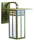 Decorative wall sconce with a rustic metal finish on a white background
