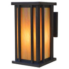 Decorative wall light with orange glass and black frame on a white background