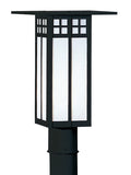 Black outdoor lamp post with glass panel on a white background