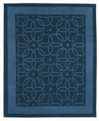 Blue geometric patterned rug on a white background