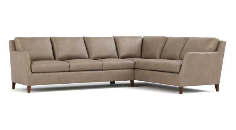 A modern sectional sofa upholstered in taupe fabric with dark wood legs, shown from a three-quarter angle on a white background.