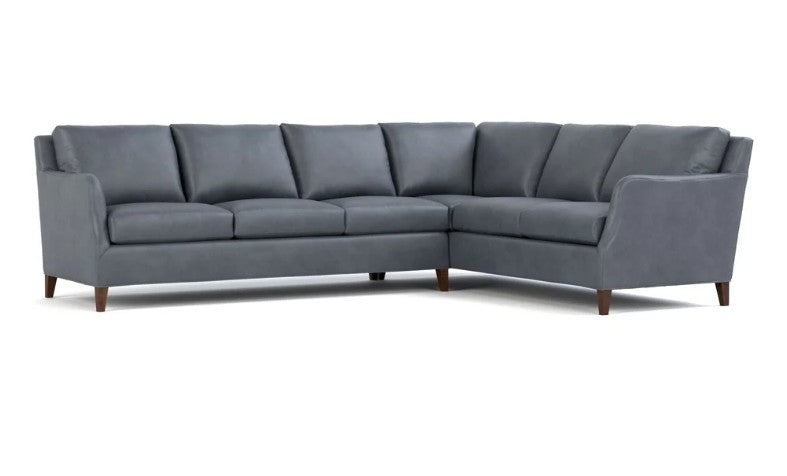 A modern gray upholstered sectional sofa with a left-facing chaise lounge and dark wood legs, shown against a plain white background.
