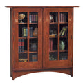 Harvey Ellis Wooden bookshelf with glass doors displaying books and decorative items on a white background