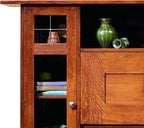 Wooden cabinet with glass panel and decorative items inside