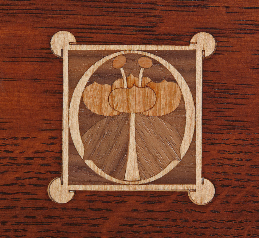 Wooden inlay design on a wooden surface.