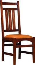 Harvey Ellis Side chair with an orange cushion. 