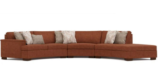 Brown sectional sofa with patterned cushions on a white background