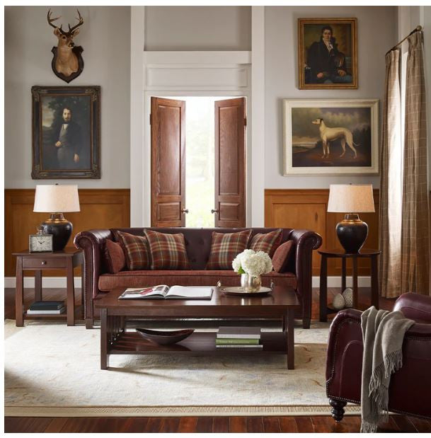 Living room with plaid sofa, wooden coffee table, and decorative elements.