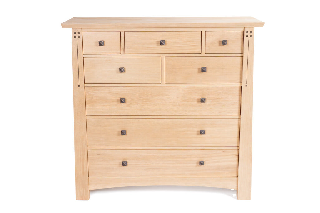 Wooden dresser with multiple drawers on a white background