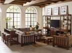 Living room with wooden furniture, including a sectional sofa, bookshelves, and a TV.