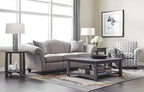 Living room with gray sofa, coffee table, and armchair near large windows.